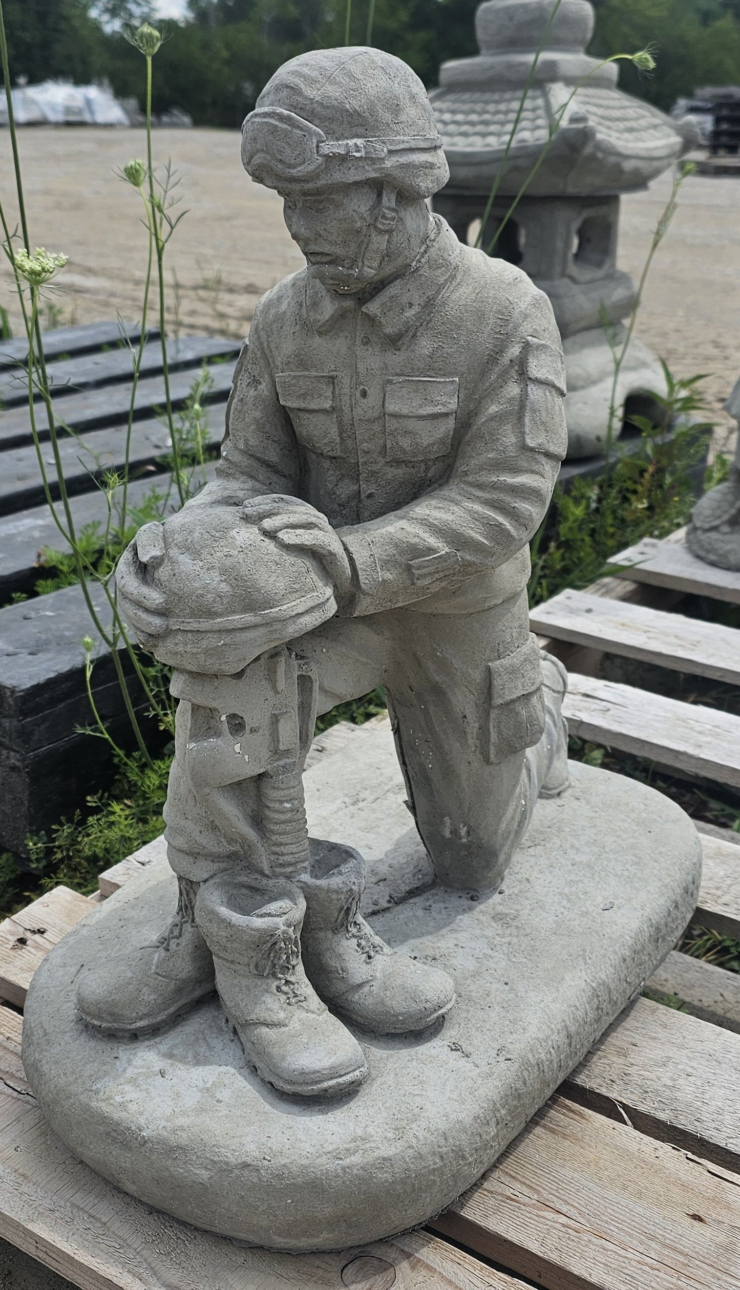 SOLDIER KNEELING BY BATTLE CROSS